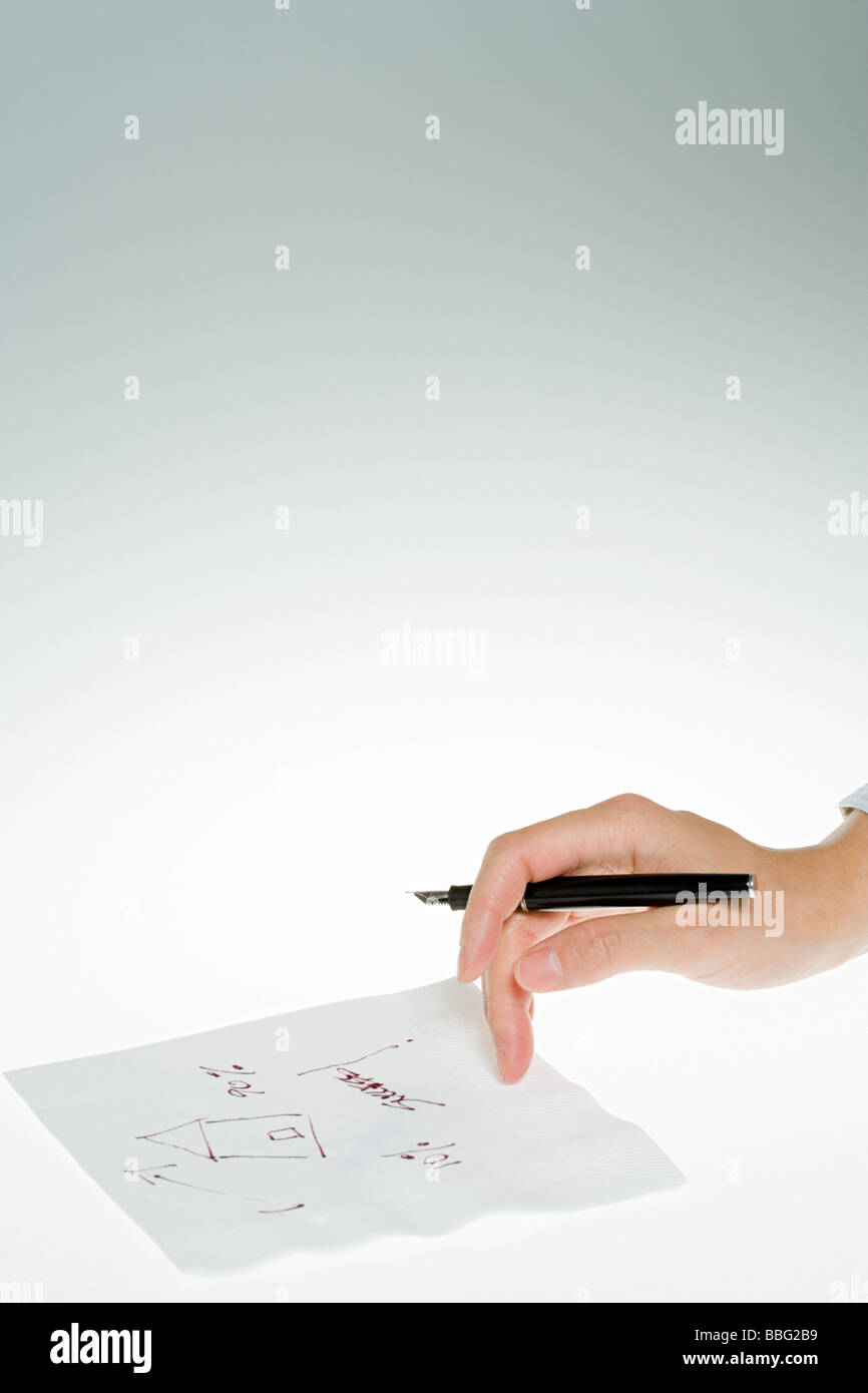 Person drawing diagram on napkin Stock Photo