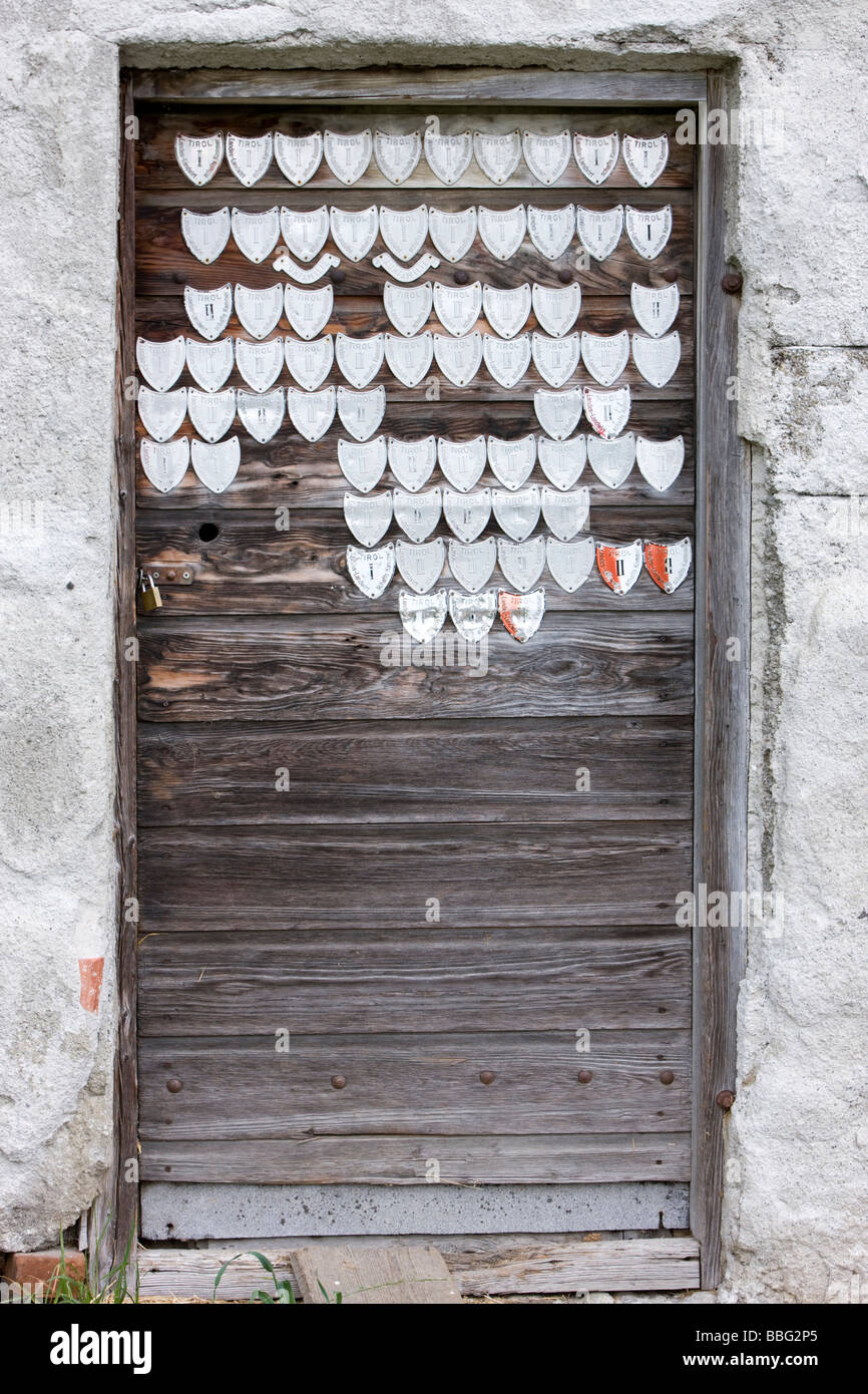 Old stable door with milk certificates, milk seals of quality, North Tyrol, Austria, Europe Stock Photo