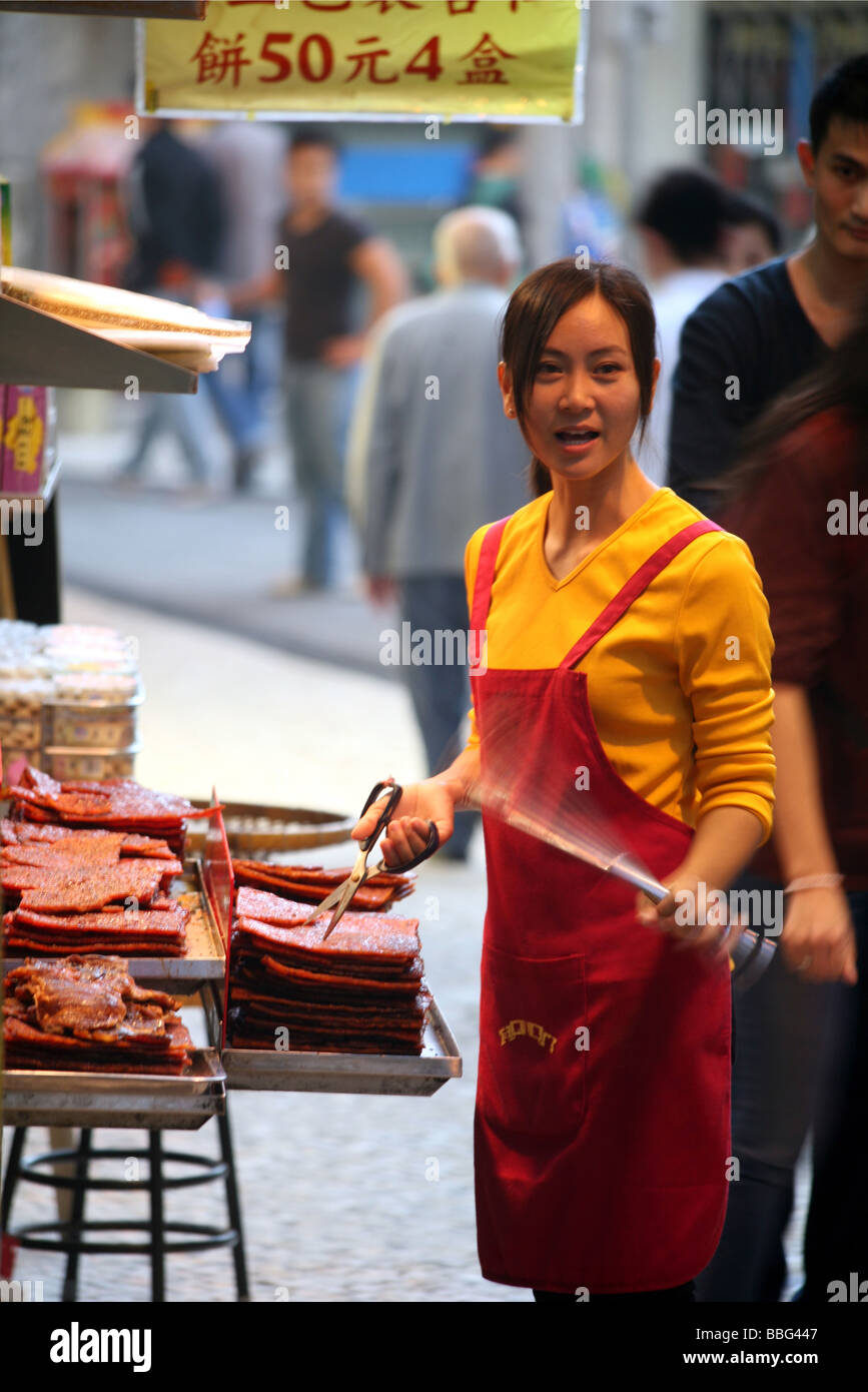 Street Hawker Selling Sheets Of Spiced Meat Stock Photo