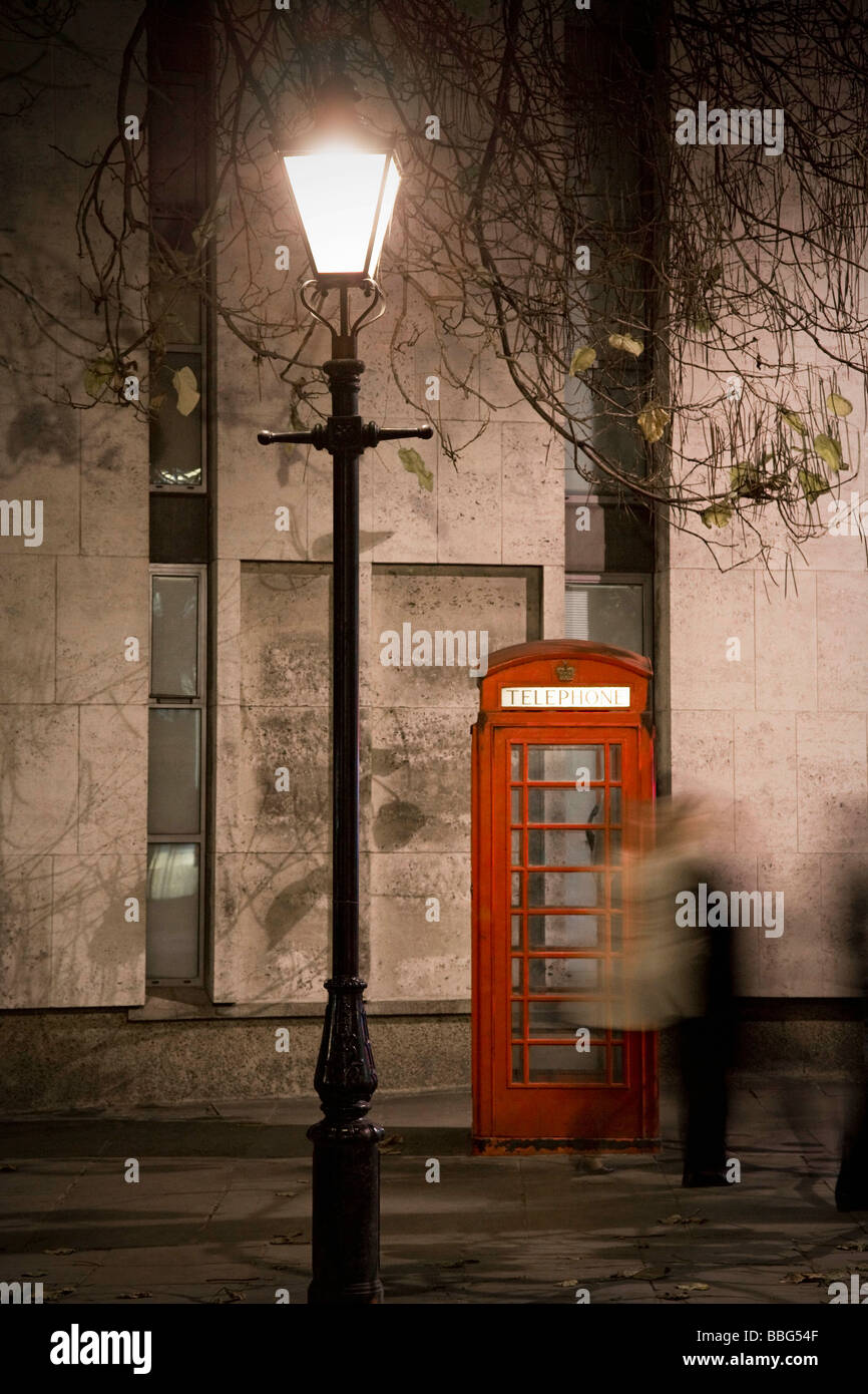 People passing red telephone box Stock Photo