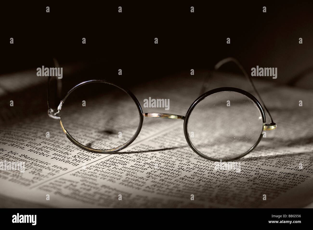 Old reading glasses on old book Stock Photo Alamy