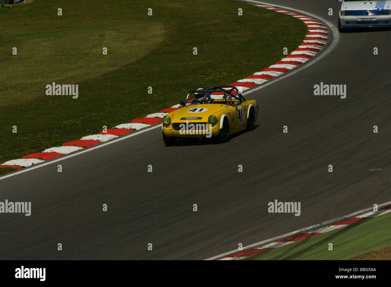 A Yellow MG Midget driven by Nigel Pratt Stock Photo