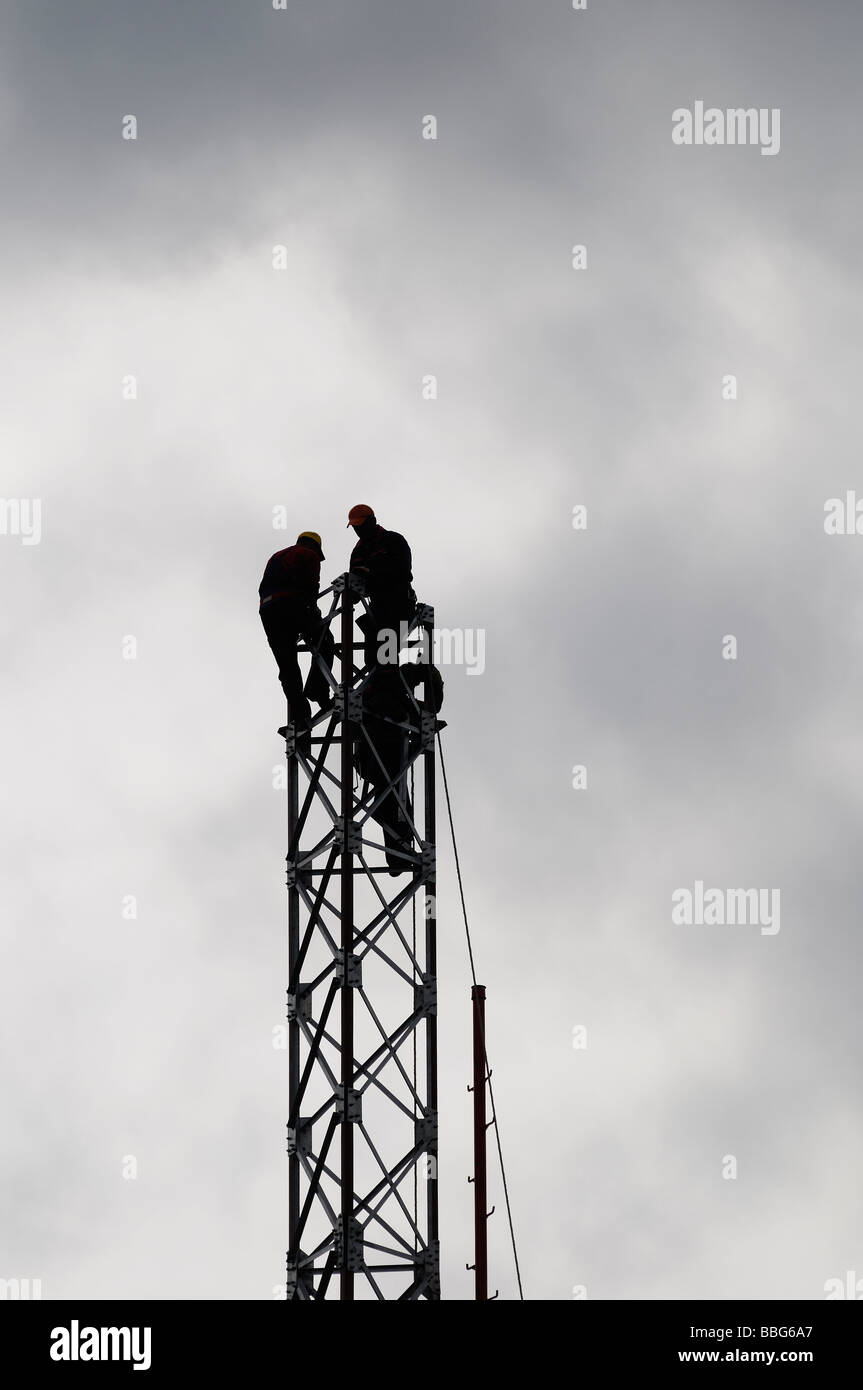 Engineers Constructing a Communications Tower Stock Photo