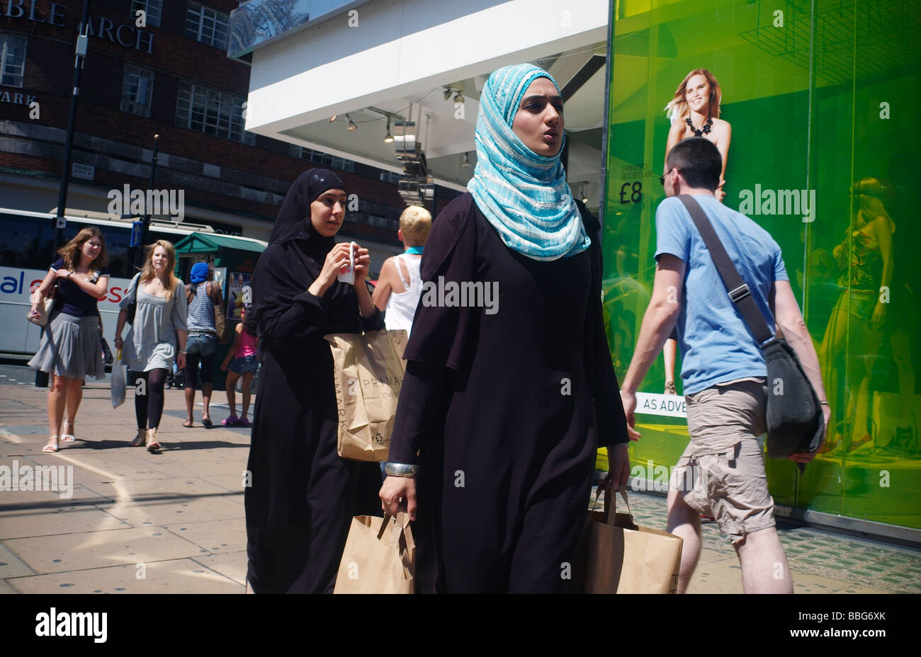 Two young Muslim Shoppers on Oxford Street London UK Stock Photo