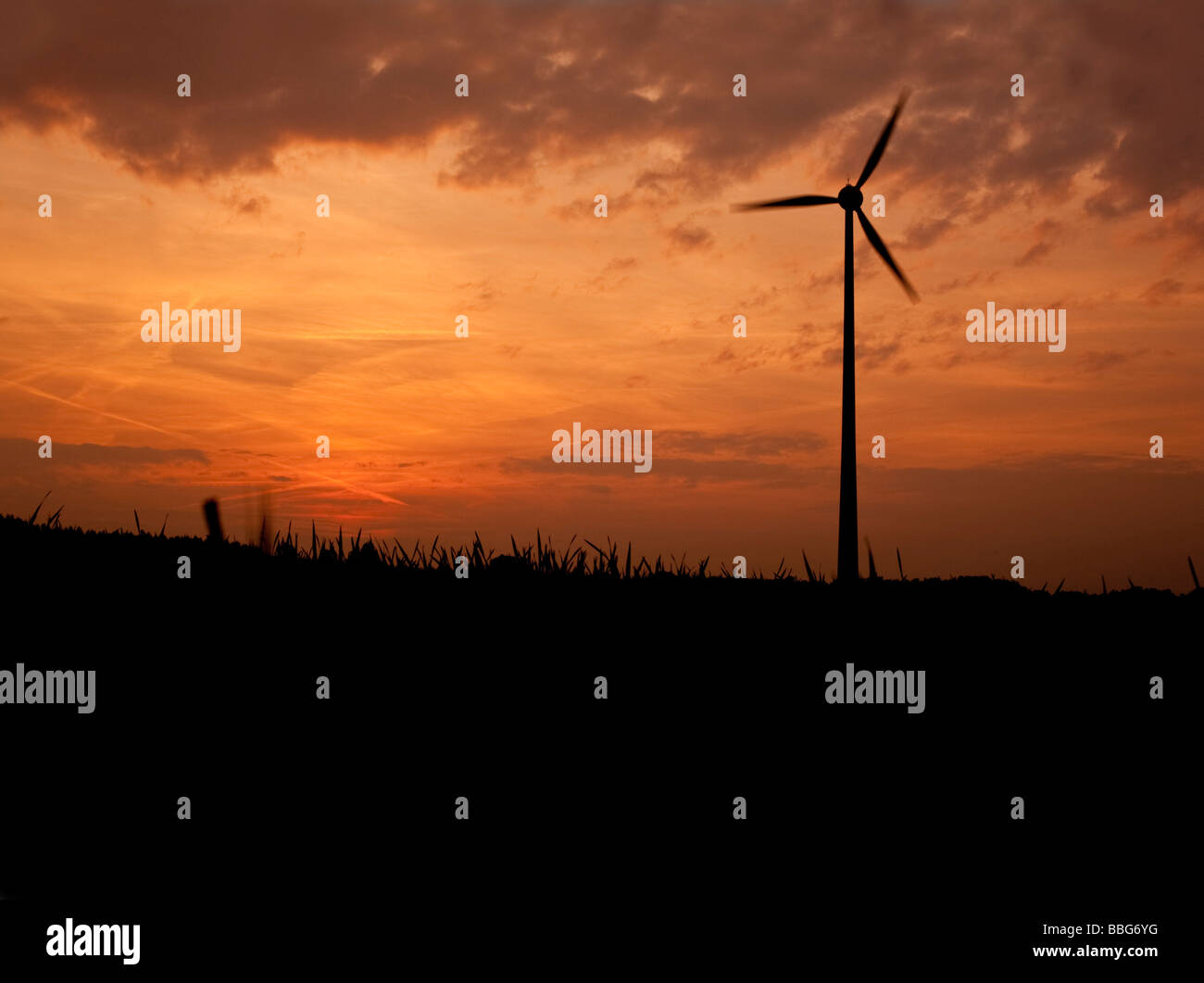 Wind power station against sunset hires stock photography and images
