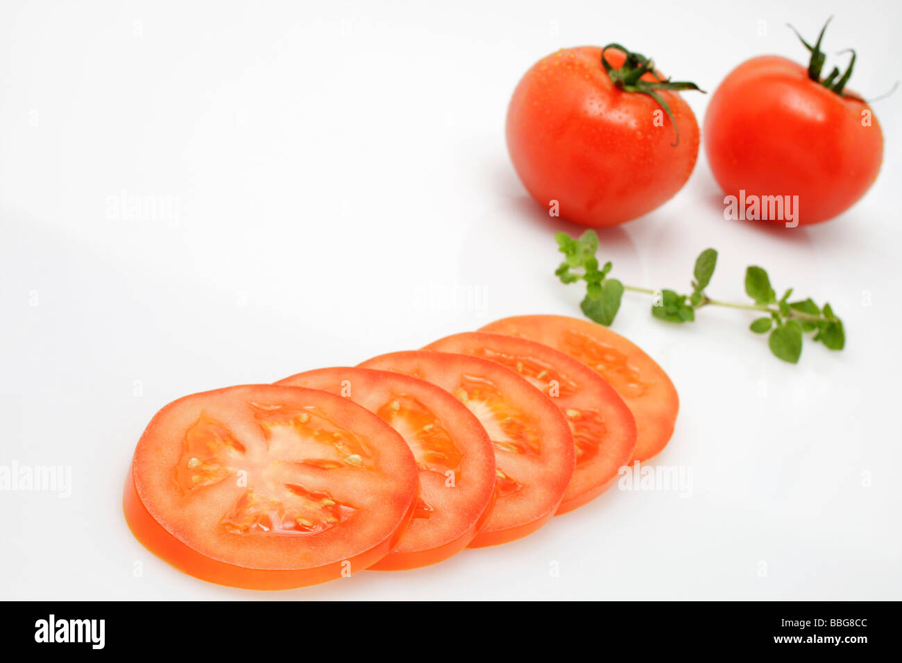 Sliced tomato and whole tomatoes Stock Photo