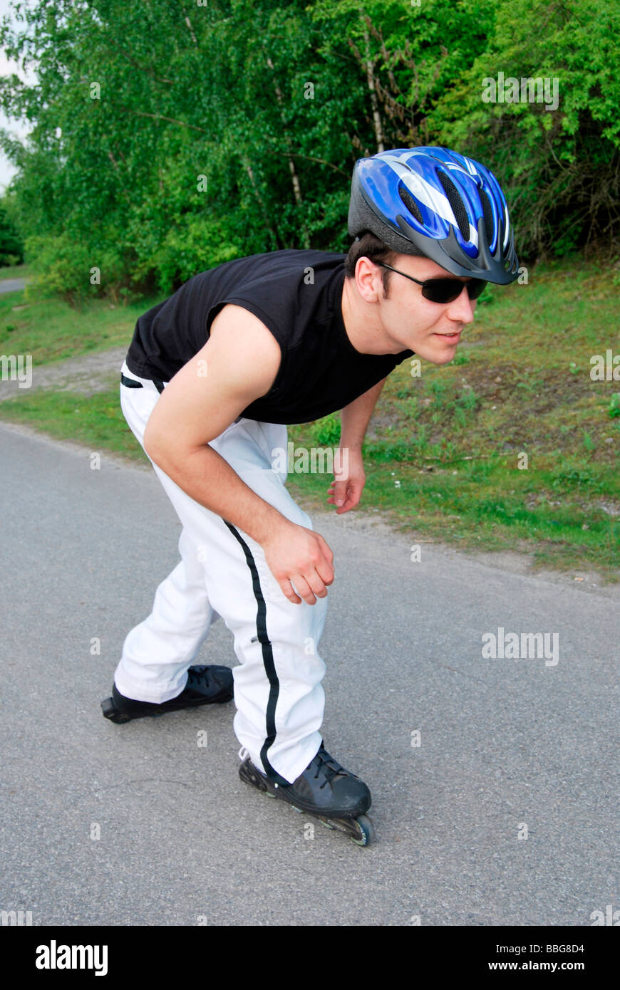 Inline skater wearing helmet and sunglasses Stock Photo Alamy
