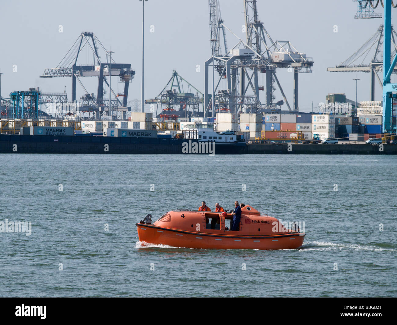 People seamen testing their liferaft lifeboat safety rescue equipment in the port of Rotterdam Zuid Holland the Netherlands Stock Photo