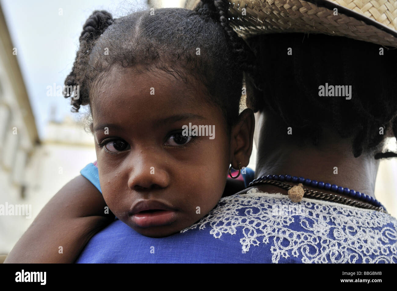 Dark-skinned girl looking over her father's shoulder, Salvador, Bahia, Brazil, South America Stock Photo