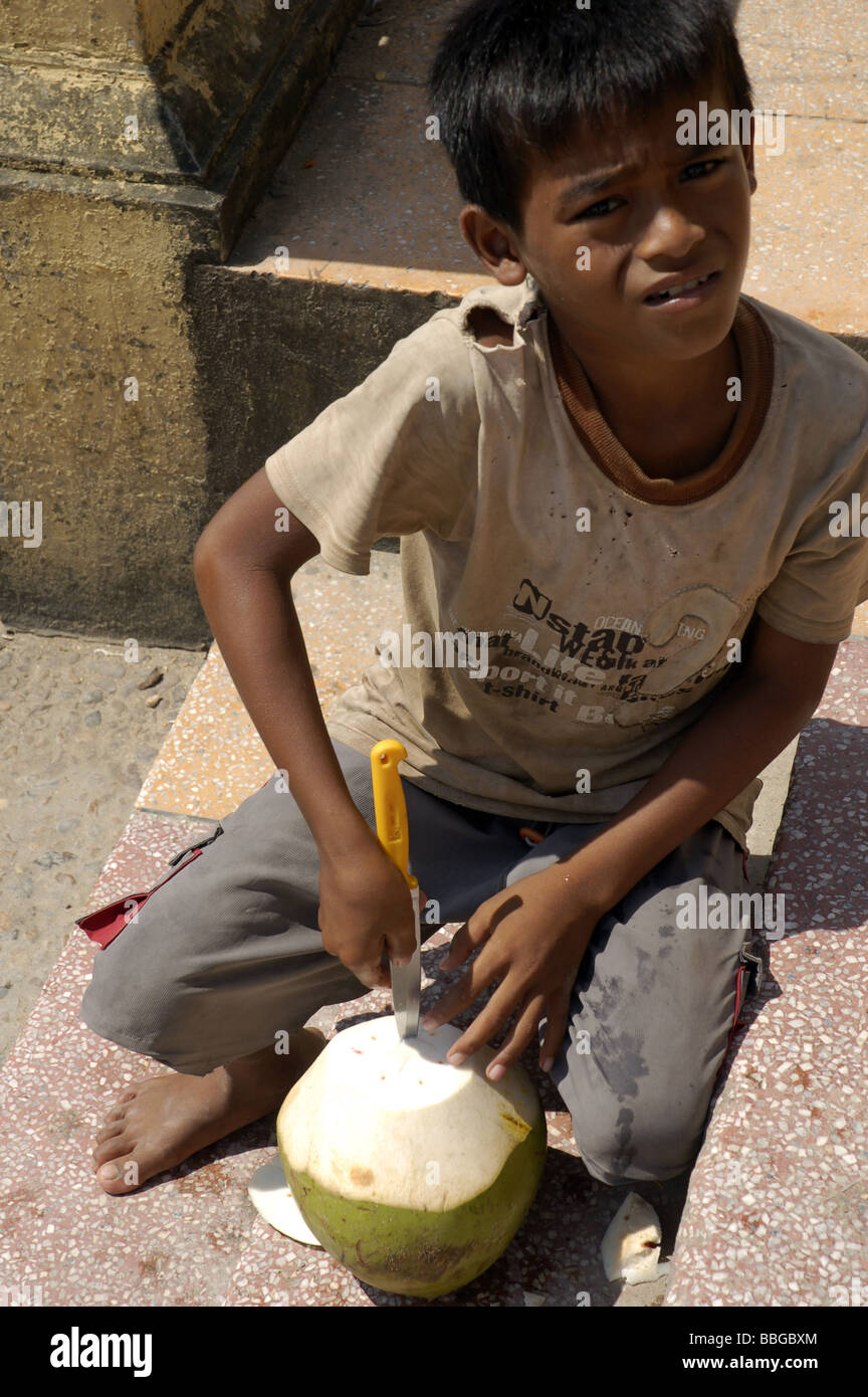 Cambodian boy drinking coconut milk in Phnom Penh, Cambodia Stock Photo
