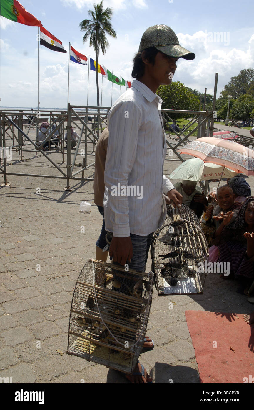 Cambodian boy selling wil birds in Phnom Penh, Cambodia Stock Photo
