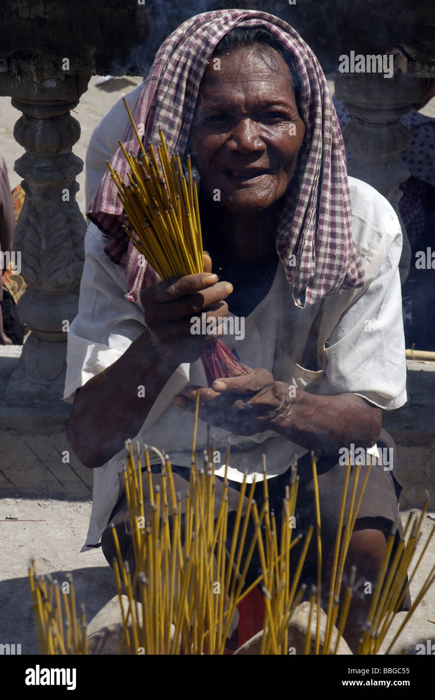 Cambodian woman praying with sticks during a religious ceremony in Phnom Penh, Cambodia Stock Photo