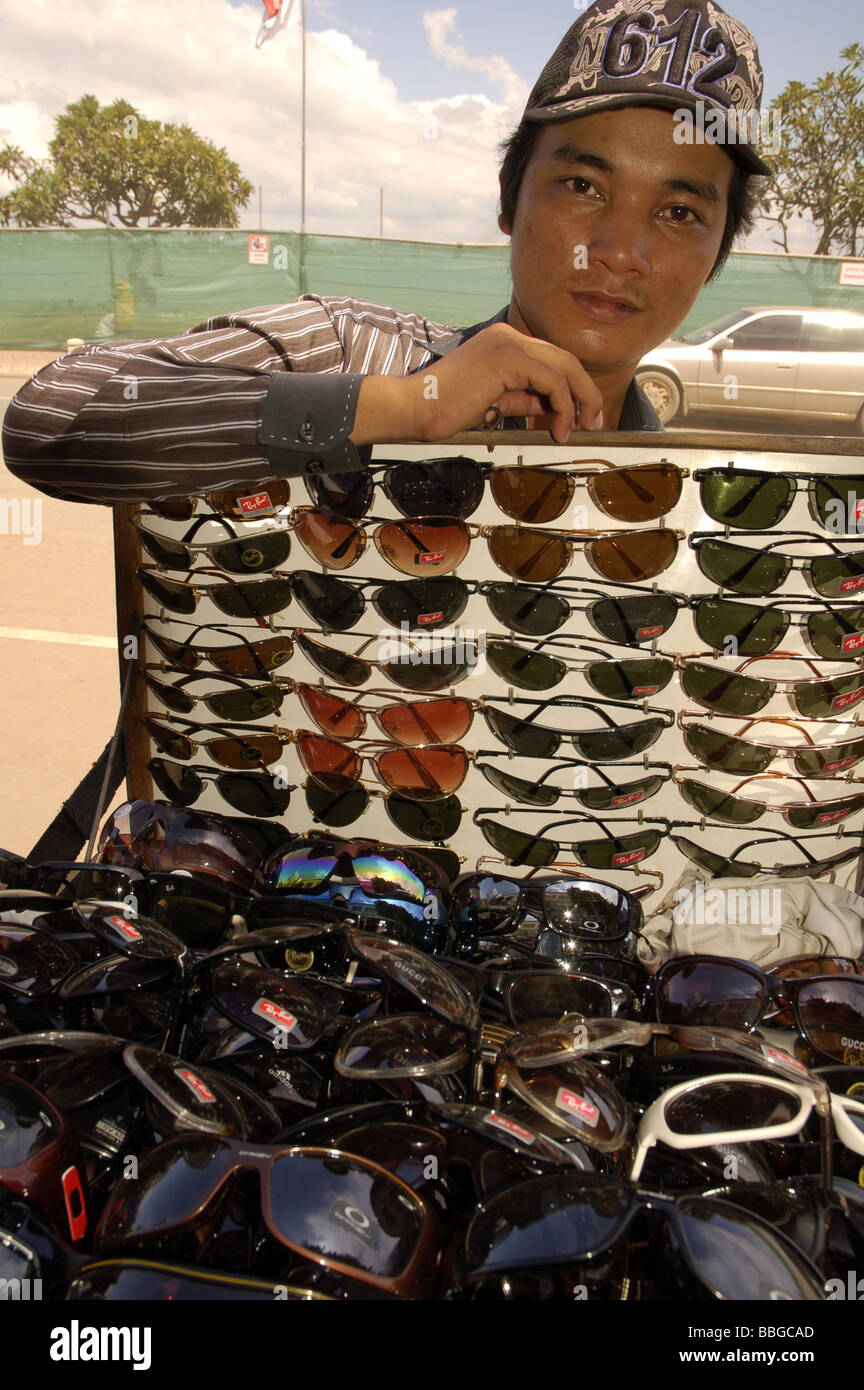 Cambodian boy selling fake sunglasses in the streets of central Phnom Penh, Cambodia Stock Photo