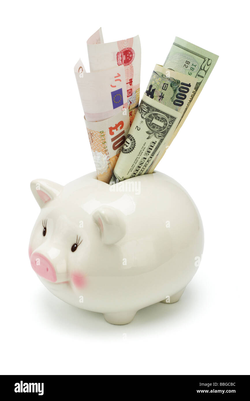 Piggy bank inserted with major world currency notes on white Stock Photo