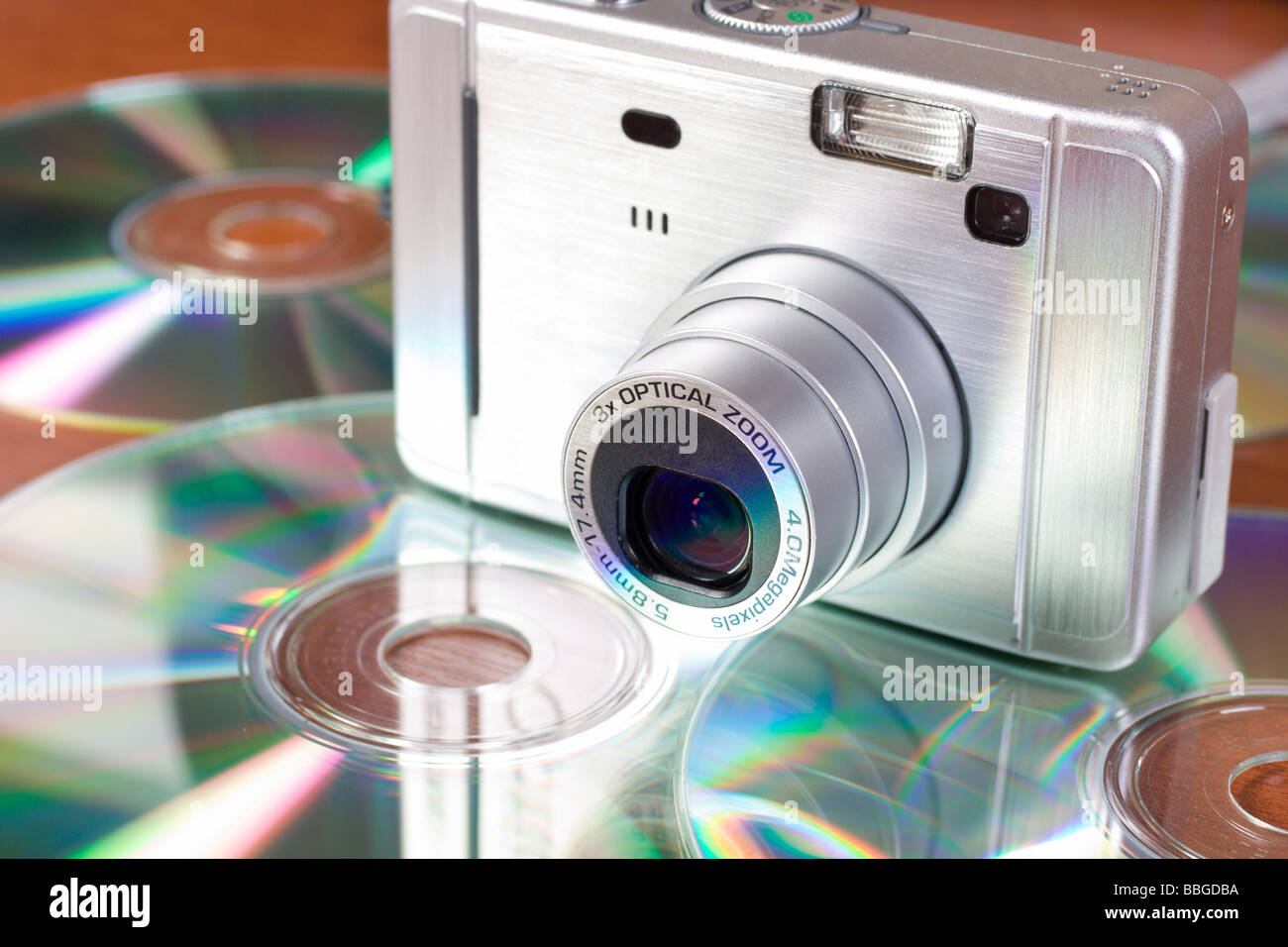 Compact digital camera and cd on the table Stock Photo Alamy