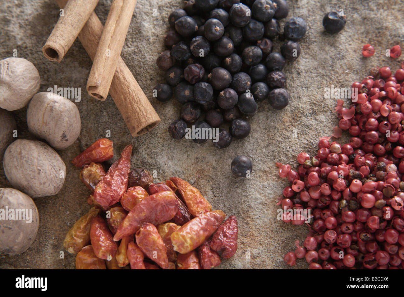 Spices, juniper, chili peppers, red pepper, nutmeg, cinnamon sticks Stock Photo