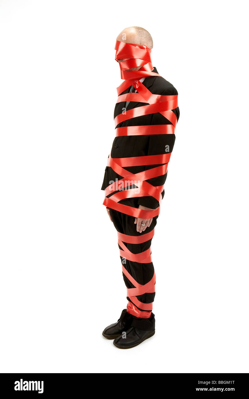 business man wrapped in red tape Stock Photo Alamy
