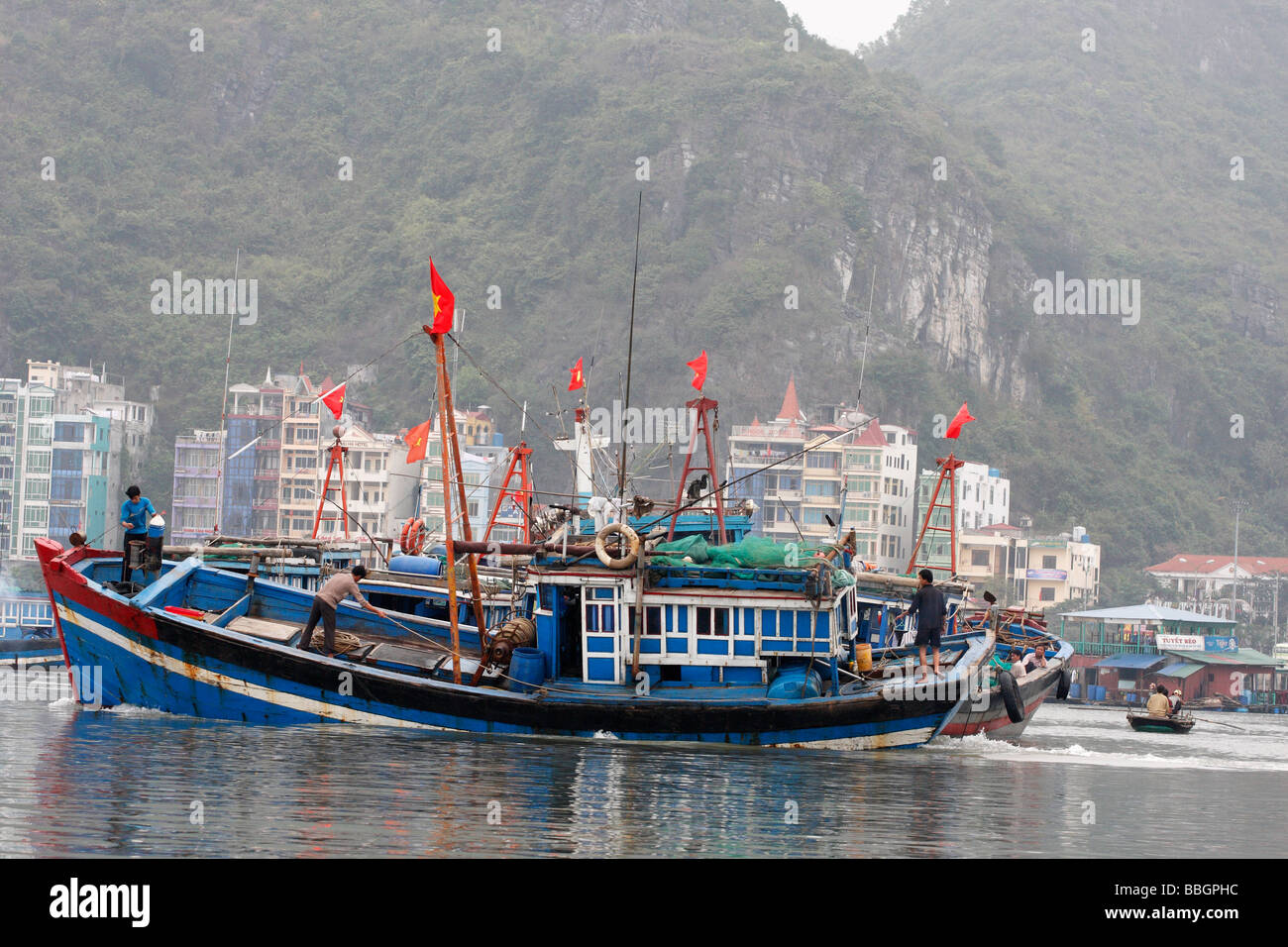Traditional Vietnamese fishing boat sailing in "Cat Ba" town harbour