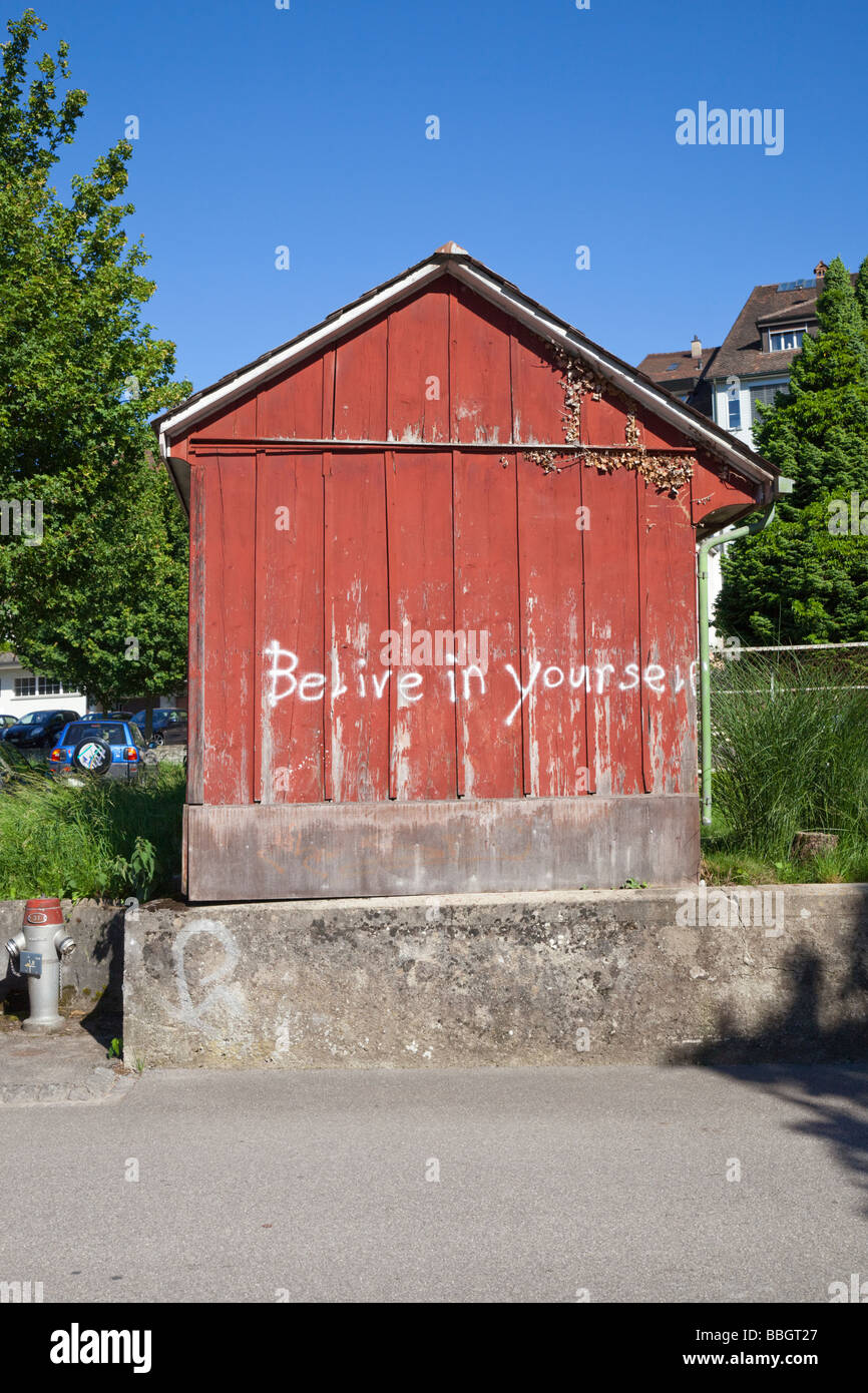 Belive in yourself wtitten on the side of barn like storage shed Stock Photo
