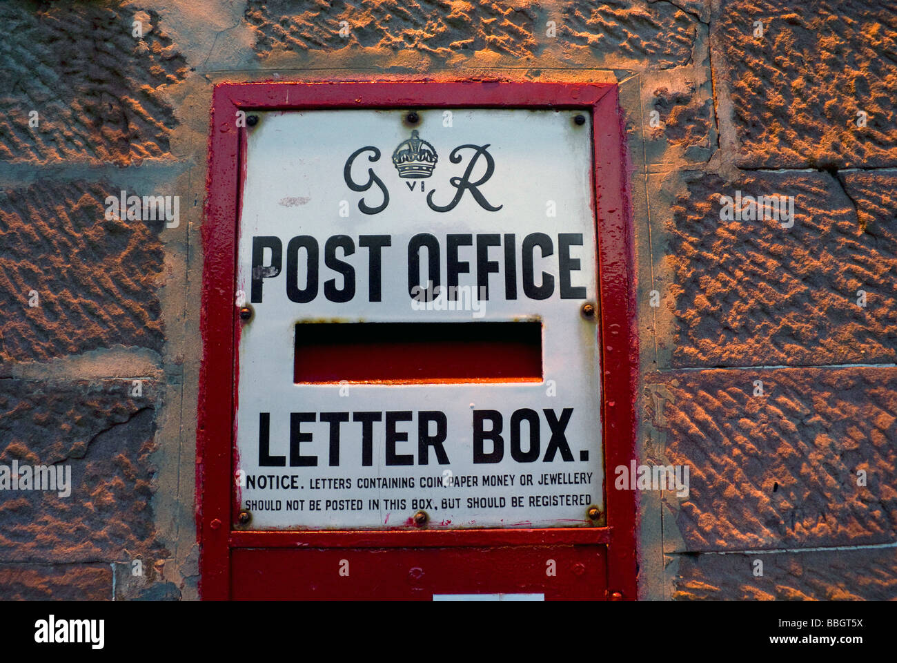 Old post office letter box mounted in a wall in Luss, Loch Lomond Stock
