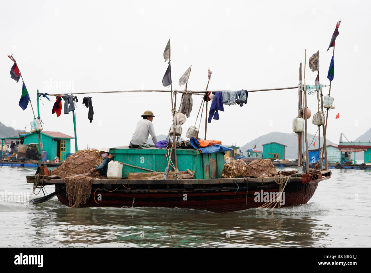 Vietnamese fishing boat and floating village, "Cat Ba" Island, [Halong