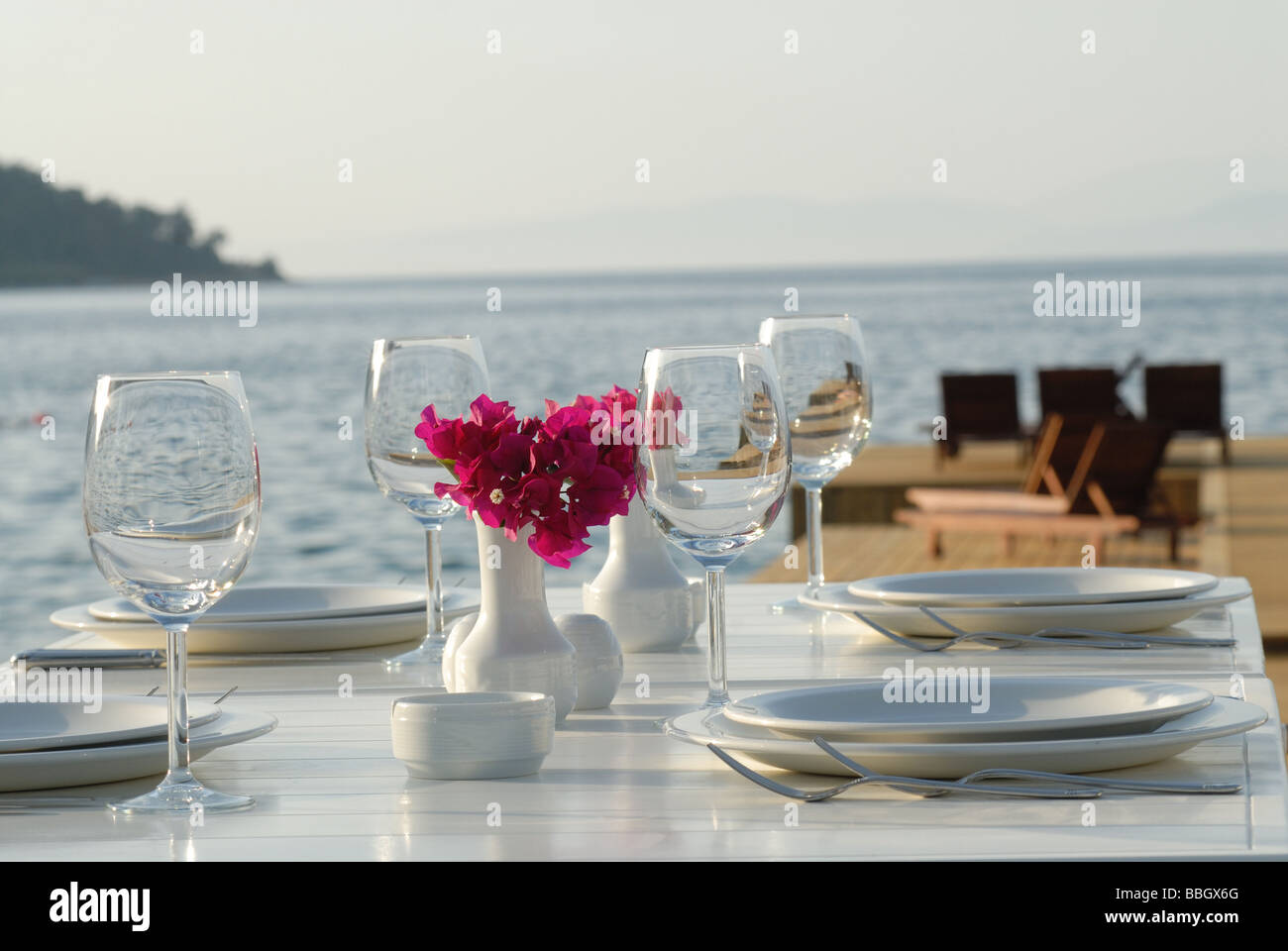 dinner table and nice place setting at the beach restaurant Stock Photo