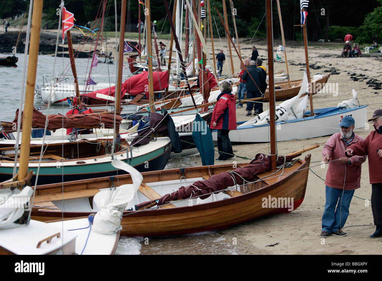 Small wooden sailboats on the beach during La Semaine du Golfe, Golfe du Morbihan, France Stock Photo