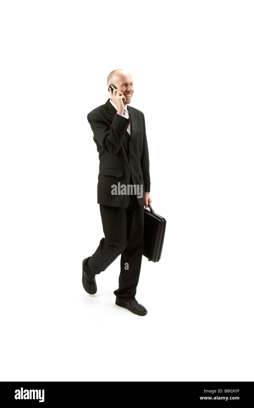 businessman in black suite walking Stock Photo
