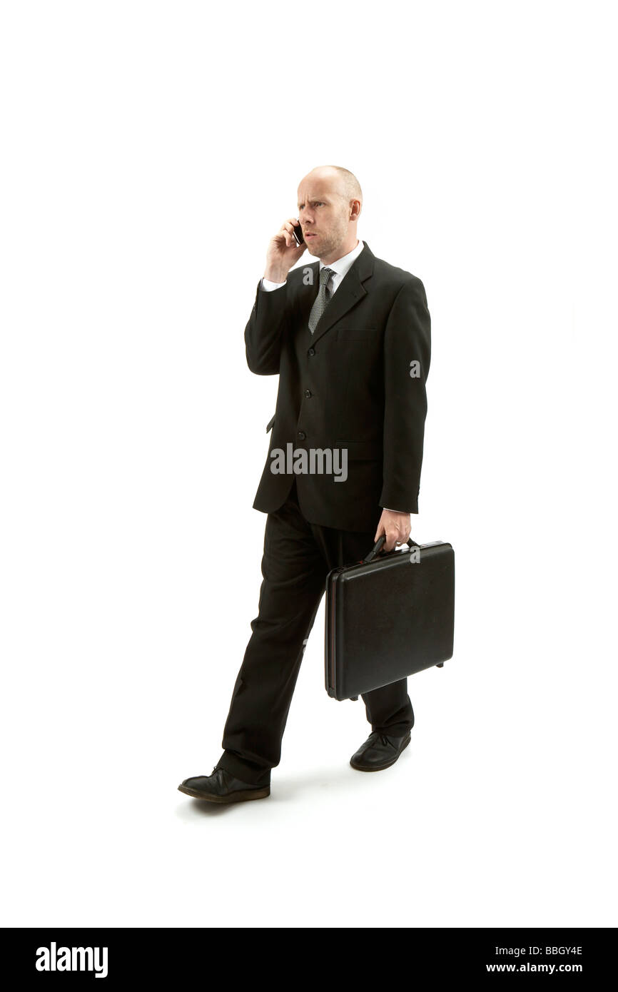 businessman in black suite walking Stock Photo