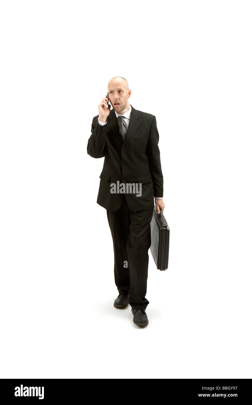 businessman in black suite walking Stock Photo