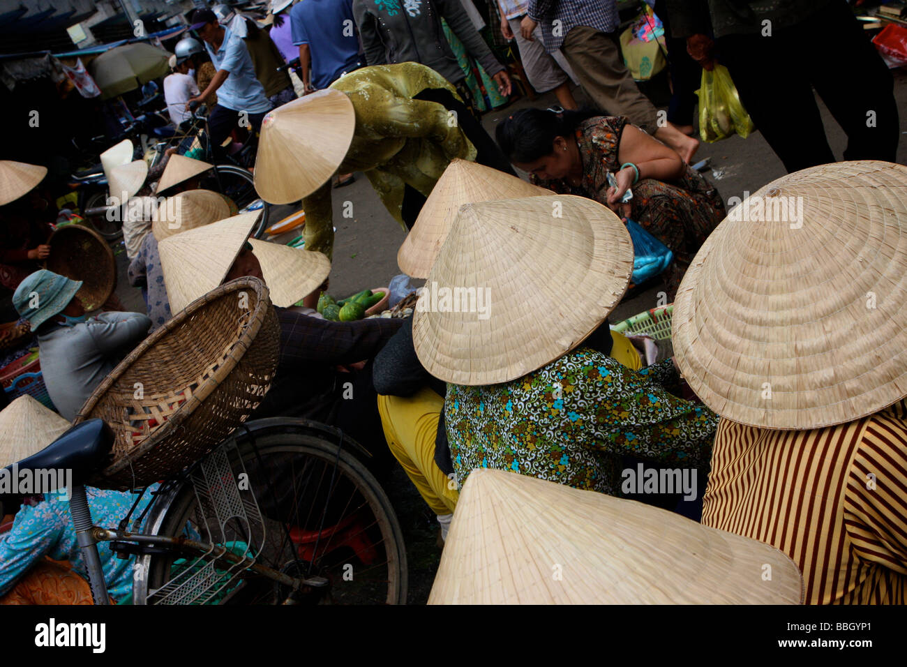 lineage of vietnamese wearing the traditional conical hat Stock Photo