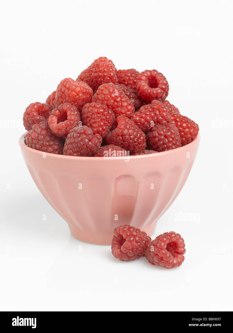 Bowl of Red Raspberries on white background Stock Photo