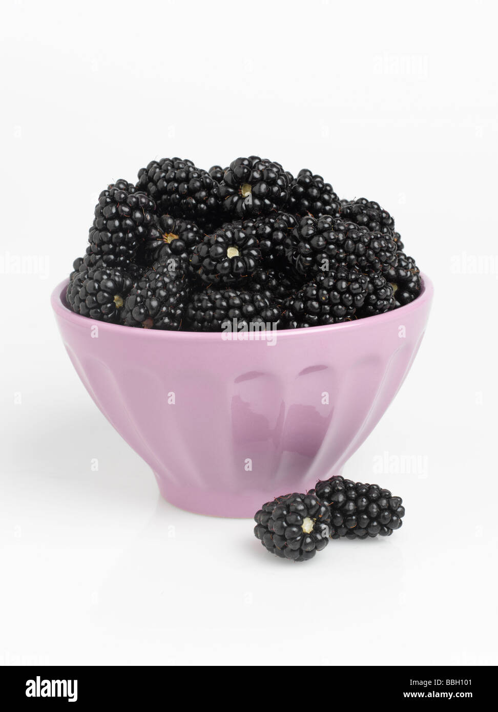 Bowl of blackberries isolated on white background Stock Photo