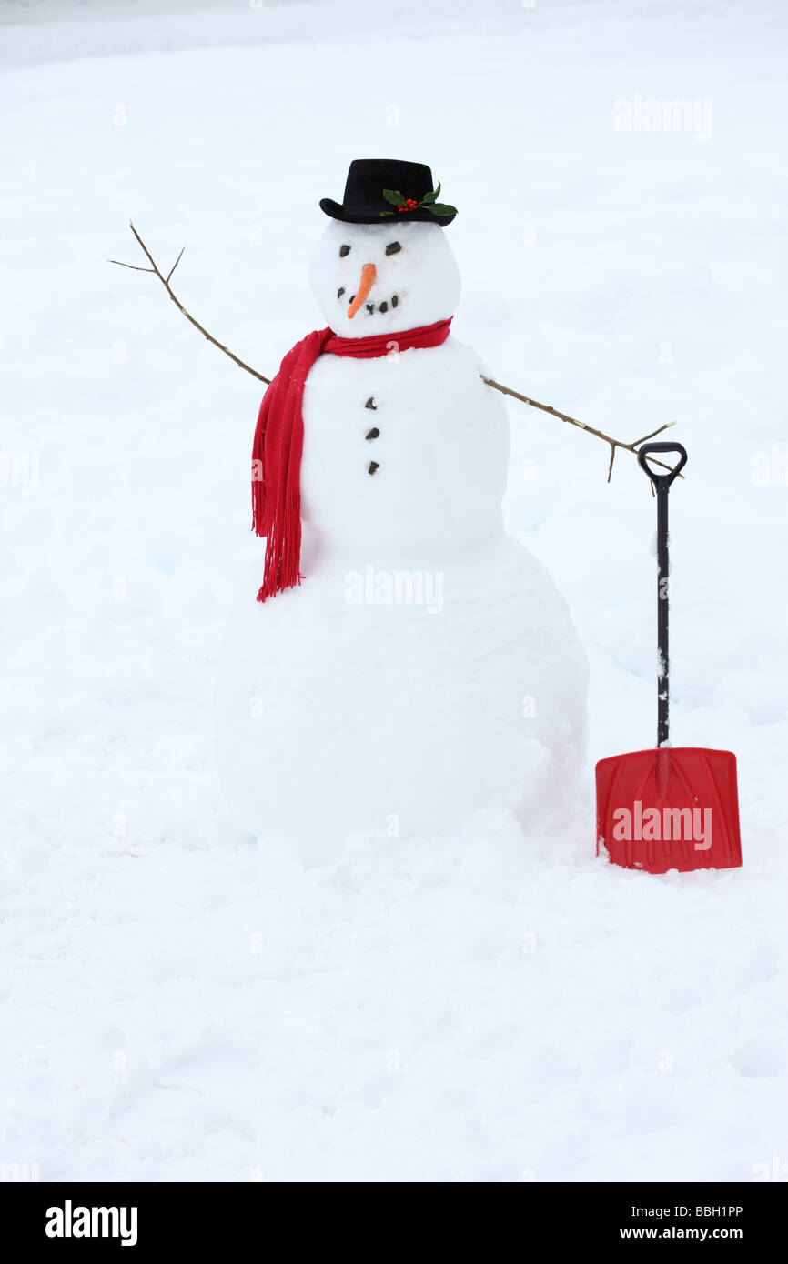 Snowman with carrot nose and red scarf Stock Photo