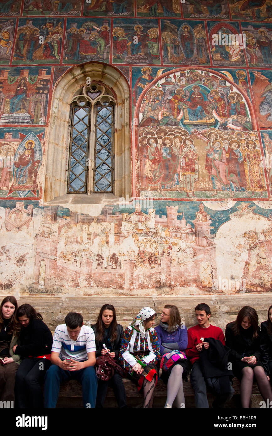 Young Romanians at Humor Painted Monastery of Bucovina decorated with 15th- 16th century frescoes Stock Photo