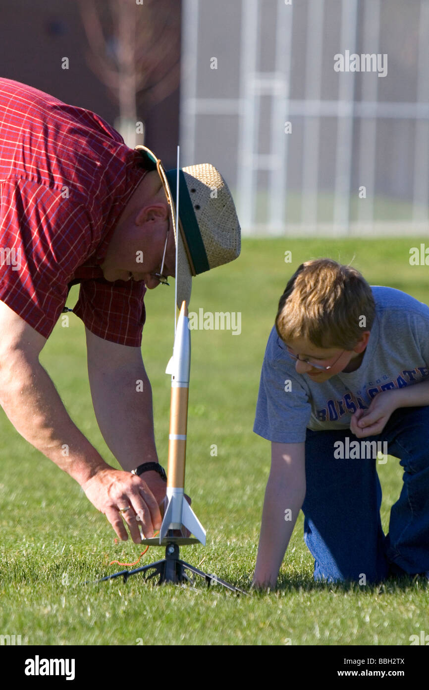 Father and son prepare to launch a model rocket for science education in Boise Idaho  Stock Photo