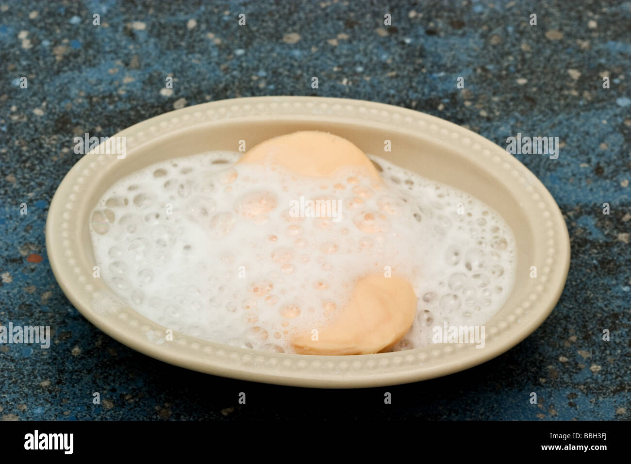 Lathered soap bar in a soap dish Stock Photo