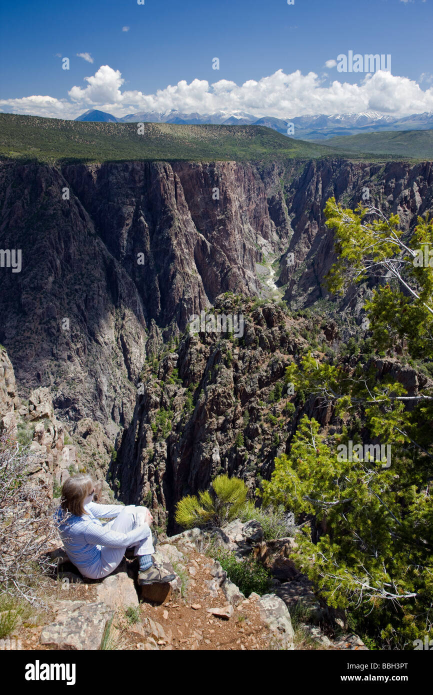Female tourist enjoying the view from Warner Point of the Black Canyon of the Gunnison National Park Colorado USA Stock Photo