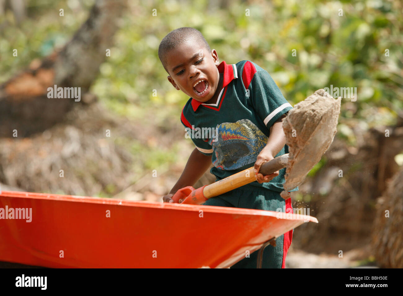Tasbapauni, Nicaragua; Boy shoveling dirt into wheelbarrow Stock Photo