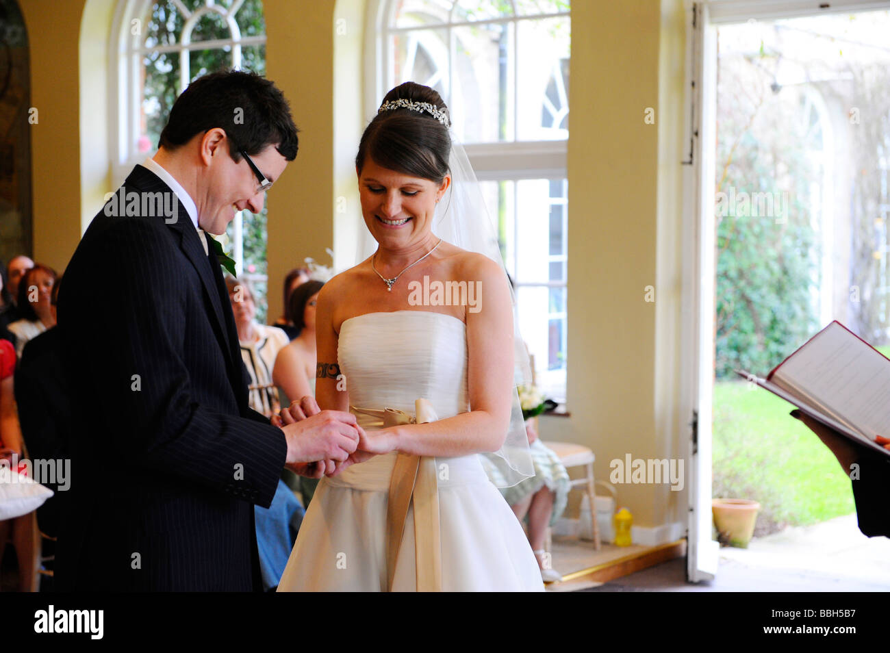 Bridal couple exchanging rings at wedding ceremony Stock Photo