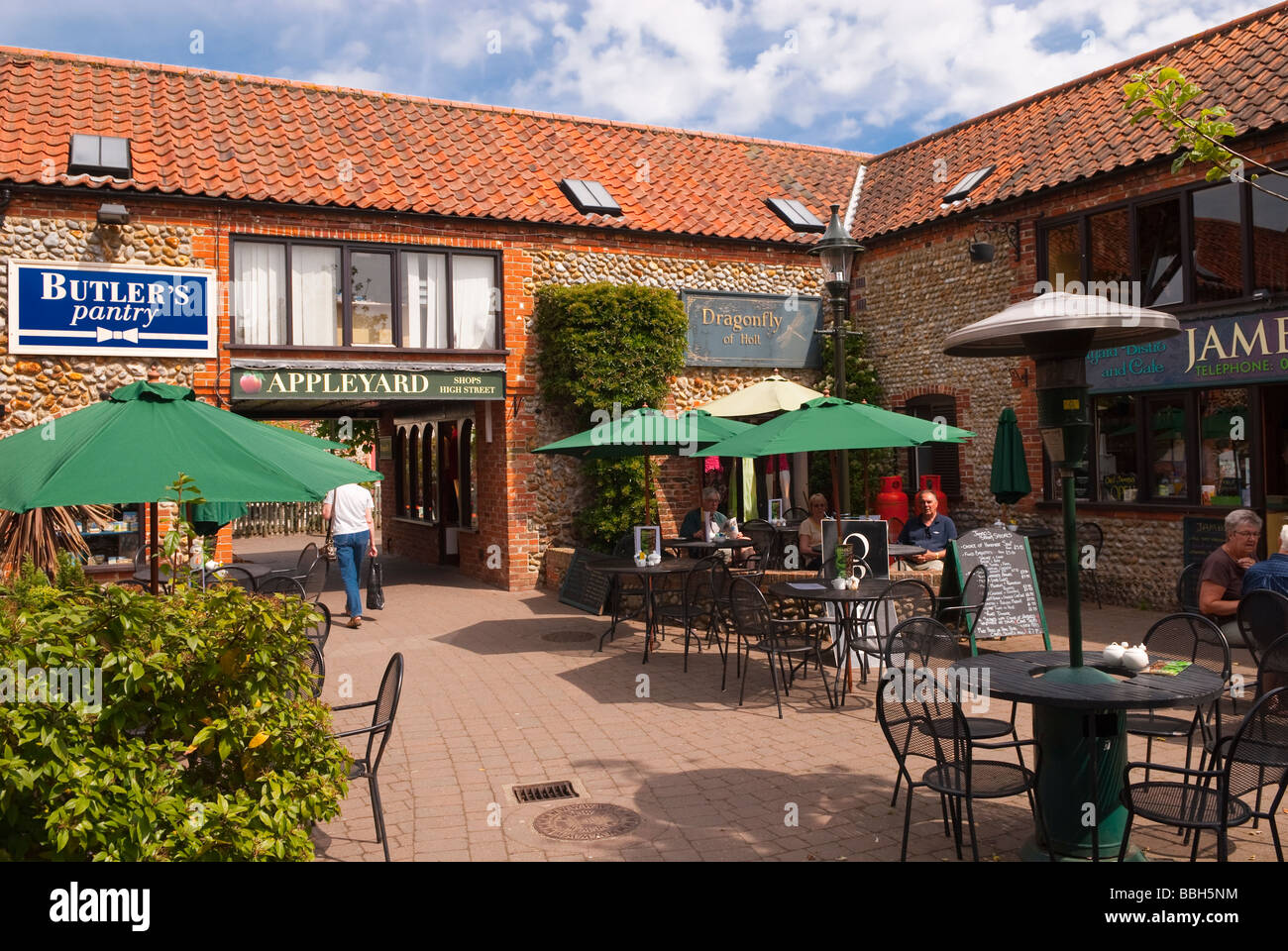 People Sitting Outdoors In The Sun Drinking Tea Coffee At The