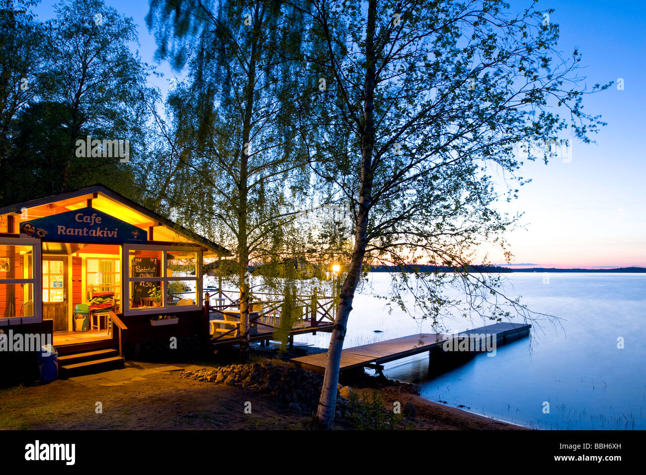 Cafe bar "Cafe Rantakivi Oy" by the lake at night Lakeland Karelia