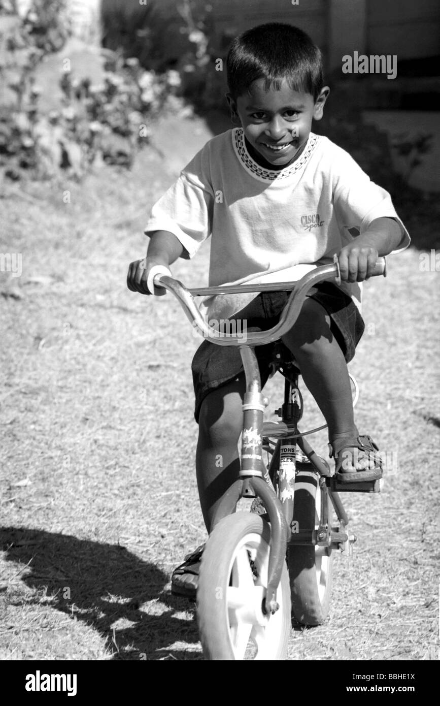 Pietermaritzburg KwaZulu Natal South Africa 9 1999 nhome children playing bicycles boys Indian bicycle biikes child Stock Photo