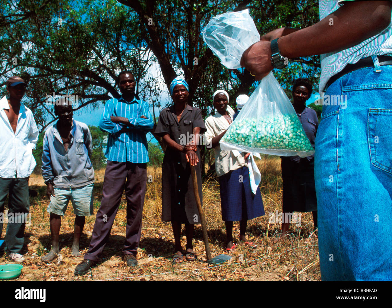 Claytus Damba holds a bag of fertilizer as he lectures members of a rural community in Ruwa outside Harare Zimbabwe in Stock Photo