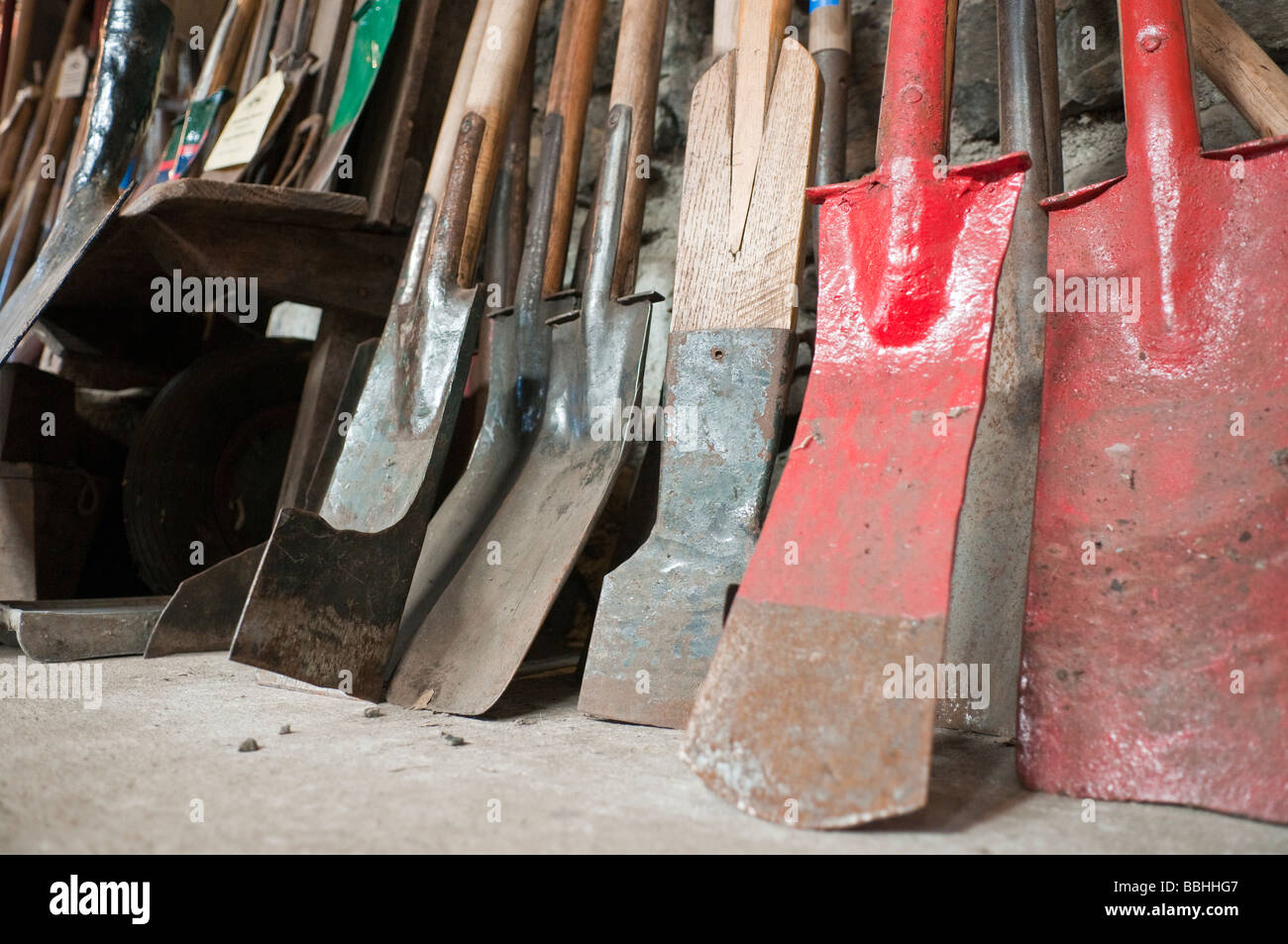 Variety of irish spades lined up against a wall Stock Photo