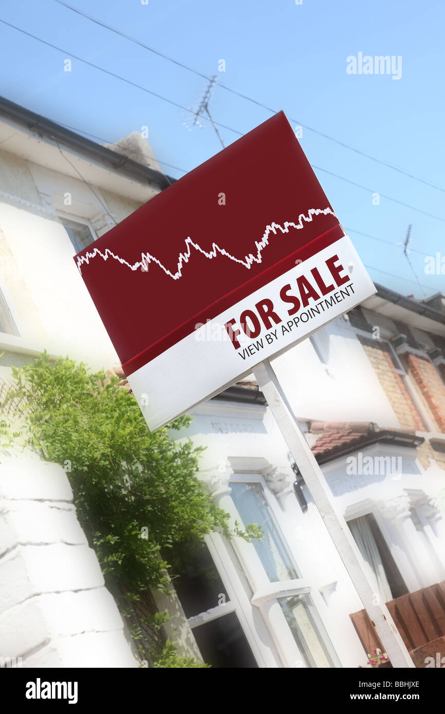 A typical estate agents board outside a row of attractive terraced houses, with a graph showing prices falling. Stock Photo