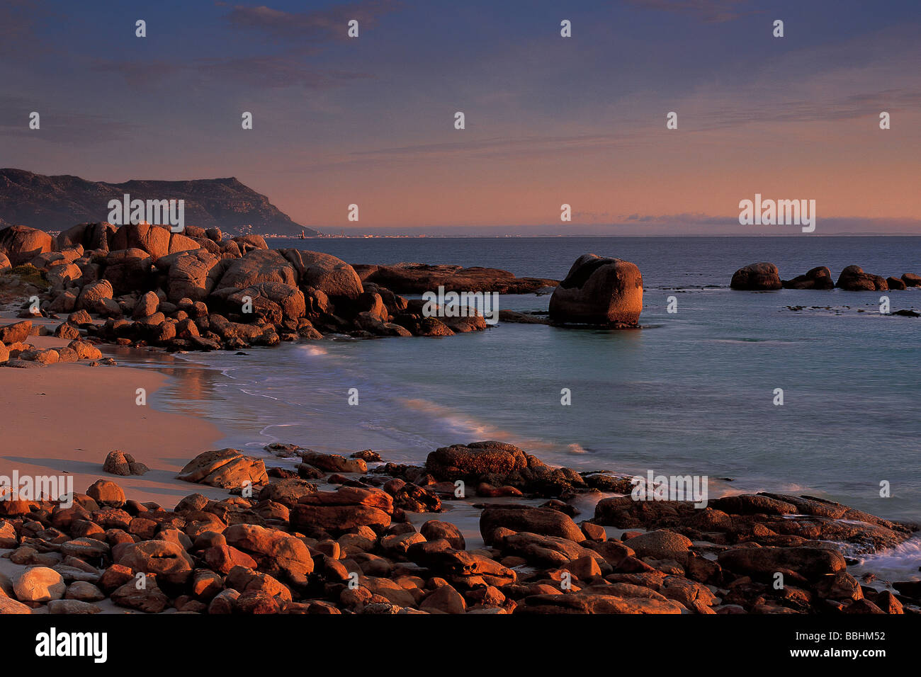 CLUSTERS OF MASSIVE GRANITE BOULDERS BREAK THE COASTLINE PROVIDING