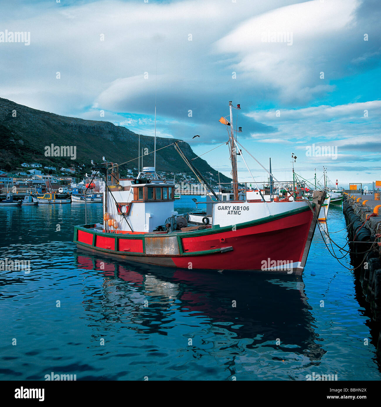 A FLEET OF WELL USED FISHING VESSELS AT KALK BAY HARBOUR Stock Photo