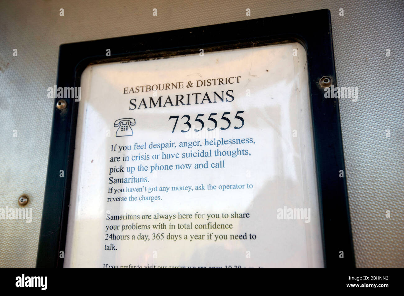 Contact details for The Samaritans around and in the public telephone box at Beachy Head, a notorious suicide spot. Stock Photo