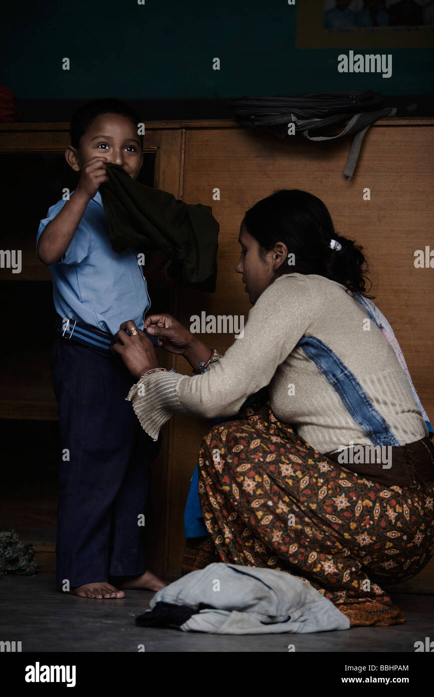 Pokhara, Nepal; Boy at orphanage being dressed got school Stock Photo
